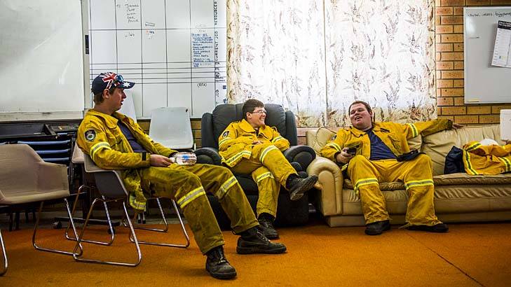 Guarded moment … Bungendore firefighters take some much-needed time out. Heatwave conditions are set to resume.