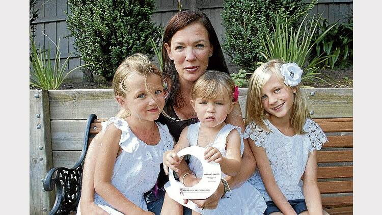 Nicole Darcey, of Newstead, with her Pink Persistence Award and daughters Olivia, 5, Matilda, 1, and Grace, 9.