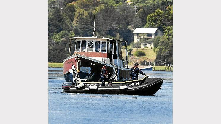 Acting Sergeant Tony Latham and Constable Nick East search the Tamar River for missing man Mark David Moylan. Mr Moylan's boat is in the background. Picture: NEIL RICHARDSON
