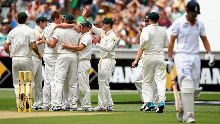 One down: Peter Siddle and the Australians celebrate after taking the wicket of Alastair Cook. Photo: Ryan Pierse