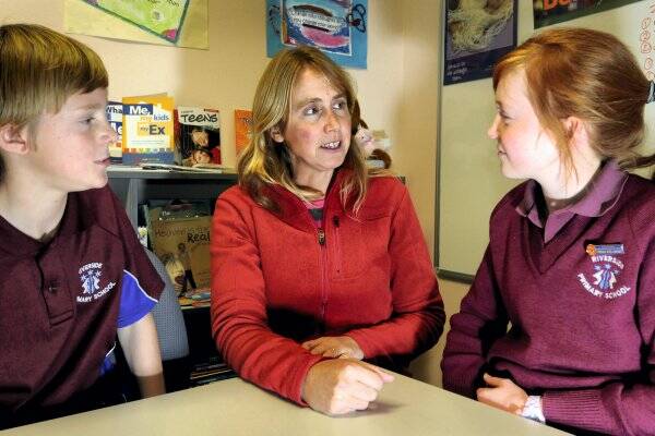 Riverside Primary School pupils Zac Camplin, 11, and Emily Ollington, 11, chat to school chaplain Lindy Bailey.  Picture: GEOFF ROBSON