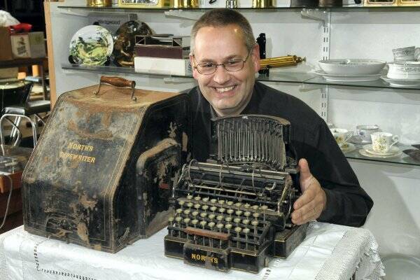 Auctioneer Peter Broadfield with a  rare typewriter that is potentially worth $10,000.  Picture: PAUL SCAMBLER