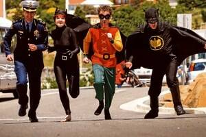Tasmania Police Commissioner Darren Hine with Riverside High School students Heloise Sowerby as Catwoman, Shane Bryan as Robin and Cameron Locke as Batman. Picture: Phillip Biggs*(1/2)