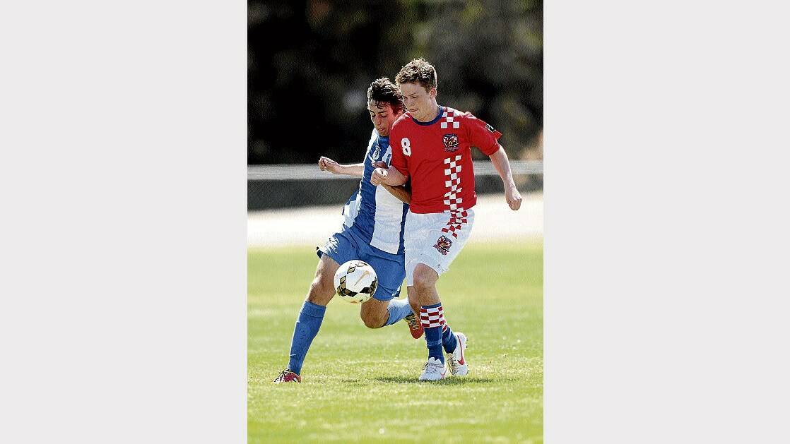 Launceston United's Stephen Lea and the Prospect Knights' Joseph McKay tussle for the ball in yesterday's Steve Hudson Cup clash. Pictures: SCOTT GELSTON