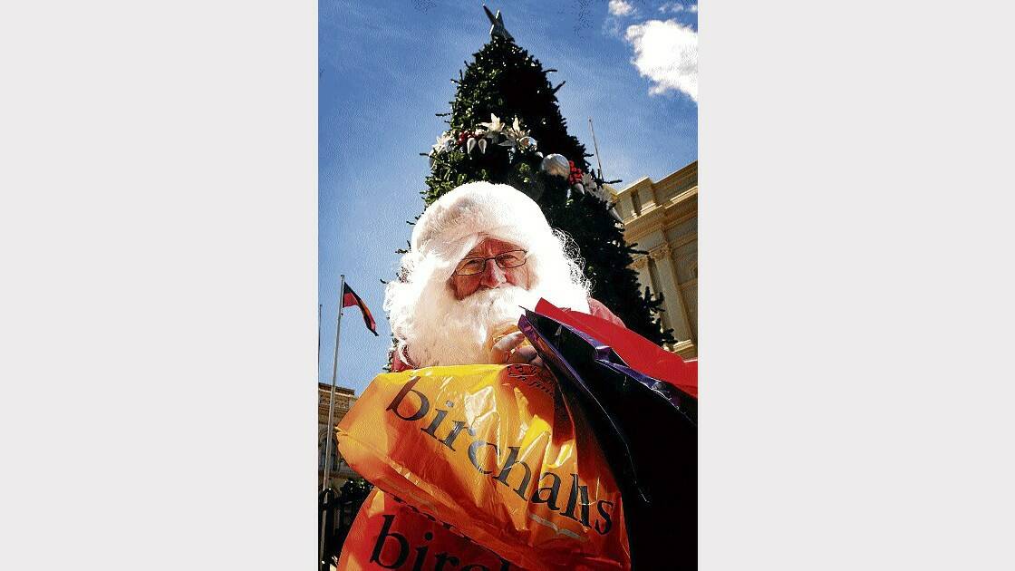 Santa called in at the Brisbane Street Mall yesterday. Picture: SCOTT GELSTON