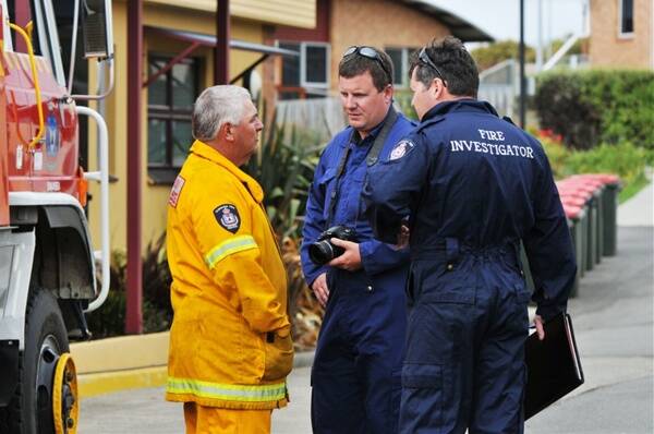 Swansea Fire Brigade chief Ken Nichols speaks to eastern districts fire investigators outside the May Shaw Health Centre. Picture: Scott Gelston