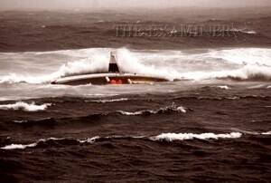 The stricken Anmaropa on its side on the St Helens barway yesterday. Picture: PAUL WILSON