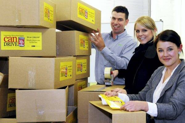 Zest advertising's Andrew Cowley, Emma Williams and Bonnie Reeves prepare collections boxes for this year's can drive.  Picture: NEIL RICHARDSON