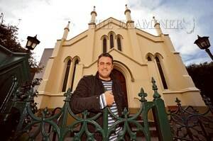 Alistair Bain, of Launceston, in front of St Andrew's Presbyterian Church. Mr Bain will tonight become the Reverend Bain when he is ordained into the church. Picture: WILL SWAN