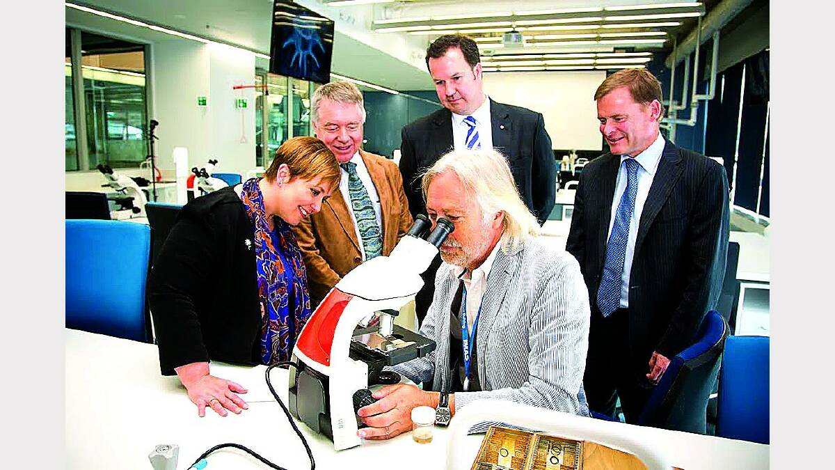 Premier Lara Giddings, IMAS executive director Mike Coffin, Senator David Bushby and University of Tasmania vice-chancellor Peter Rathjen with Professor Gustaaf Hallegraeff looking at a sample of Derwent River water at yesterday's opening of the new IMAS facility in Hobart. Picture: PETER MATHEW