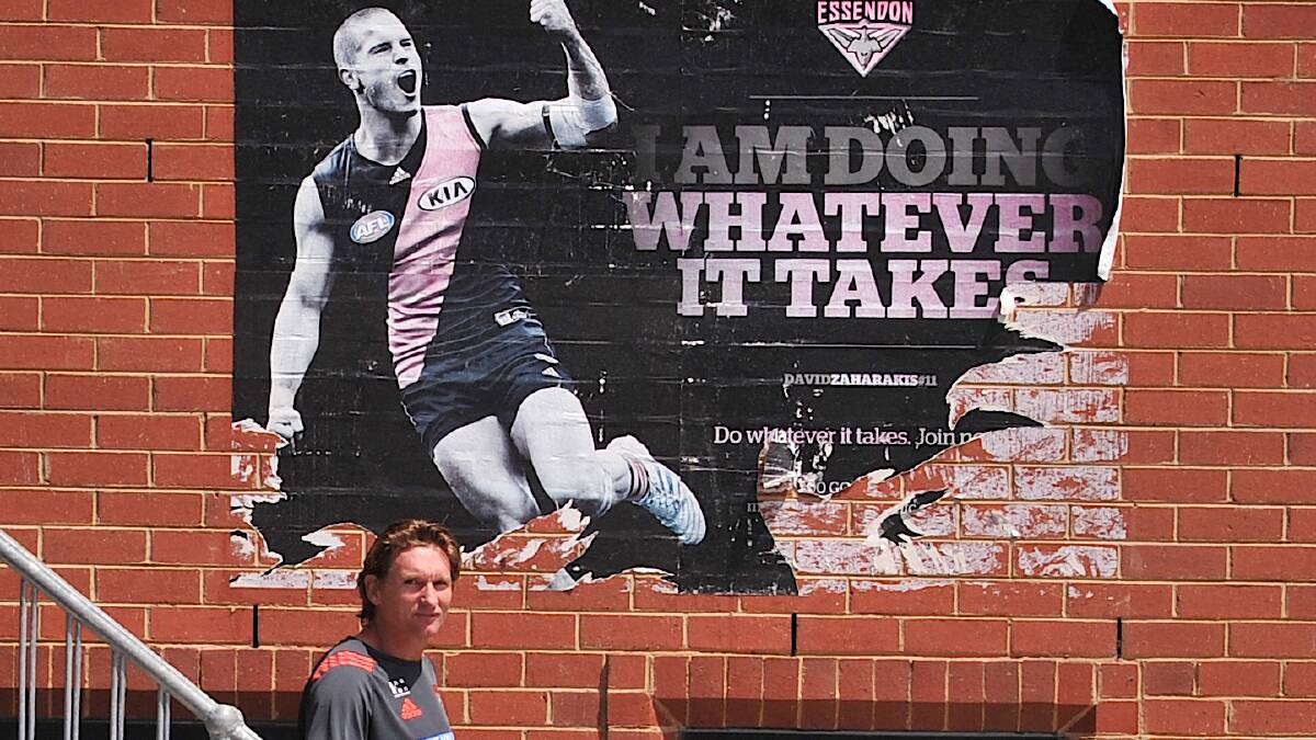 Essendon coach James Hird at the club's Windy Hill headquarters, with the club's 2013 promotional slogan above him. Photo: WAYNE TAYLOR