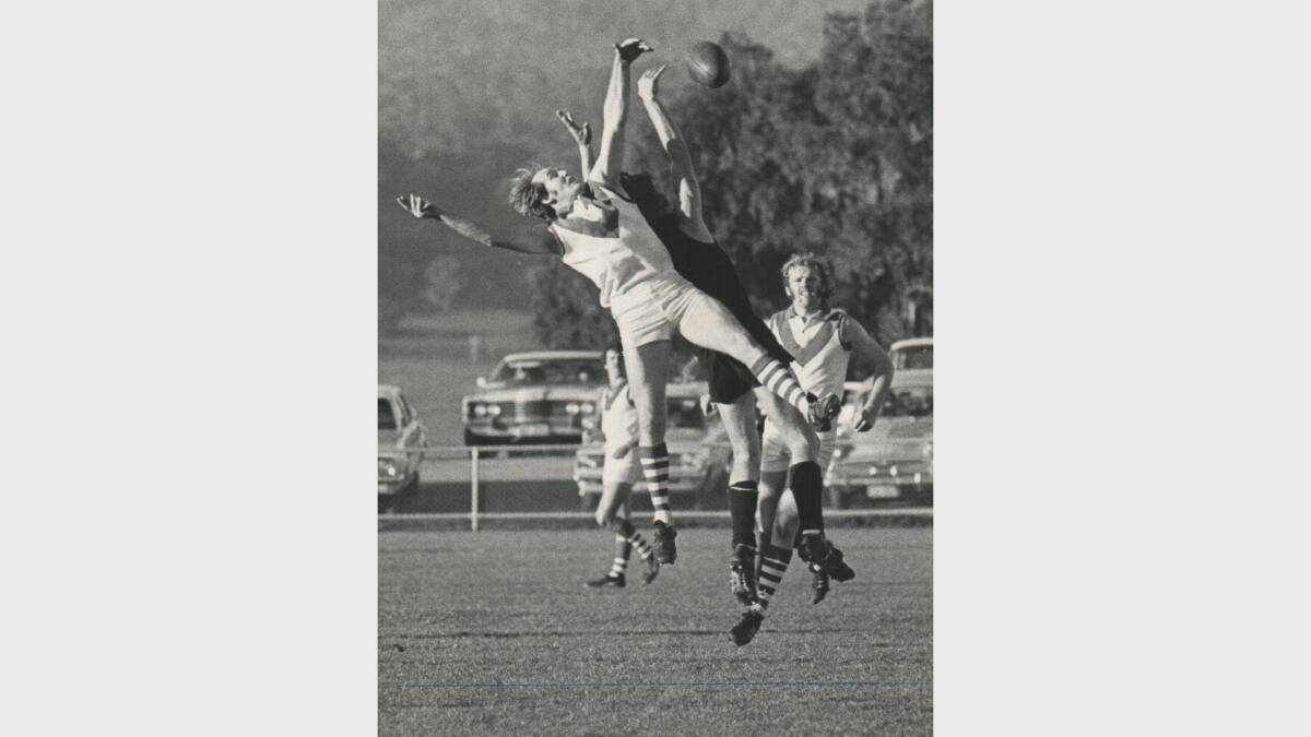 City-South player Stephen Hortle eludes Launceston's Barry McAliece during a match at Young Town. 1974.