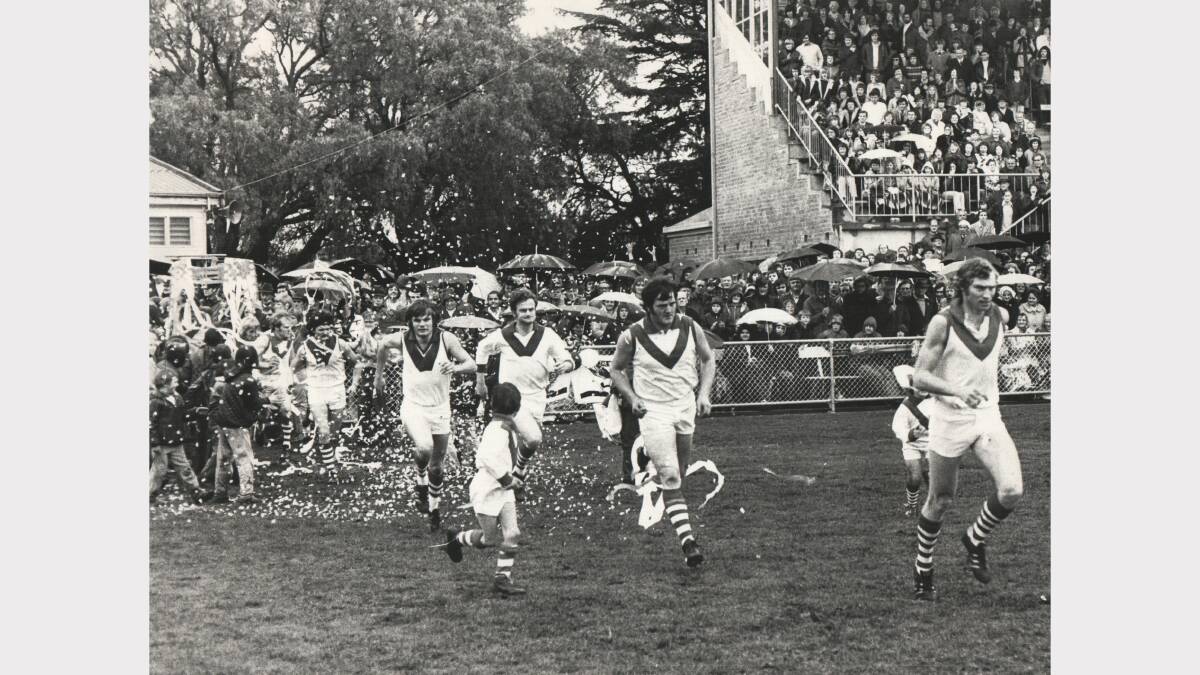 City-South's Stuart Barclay leads his team into York Park for the 1974 grand final against Scottsdale.
