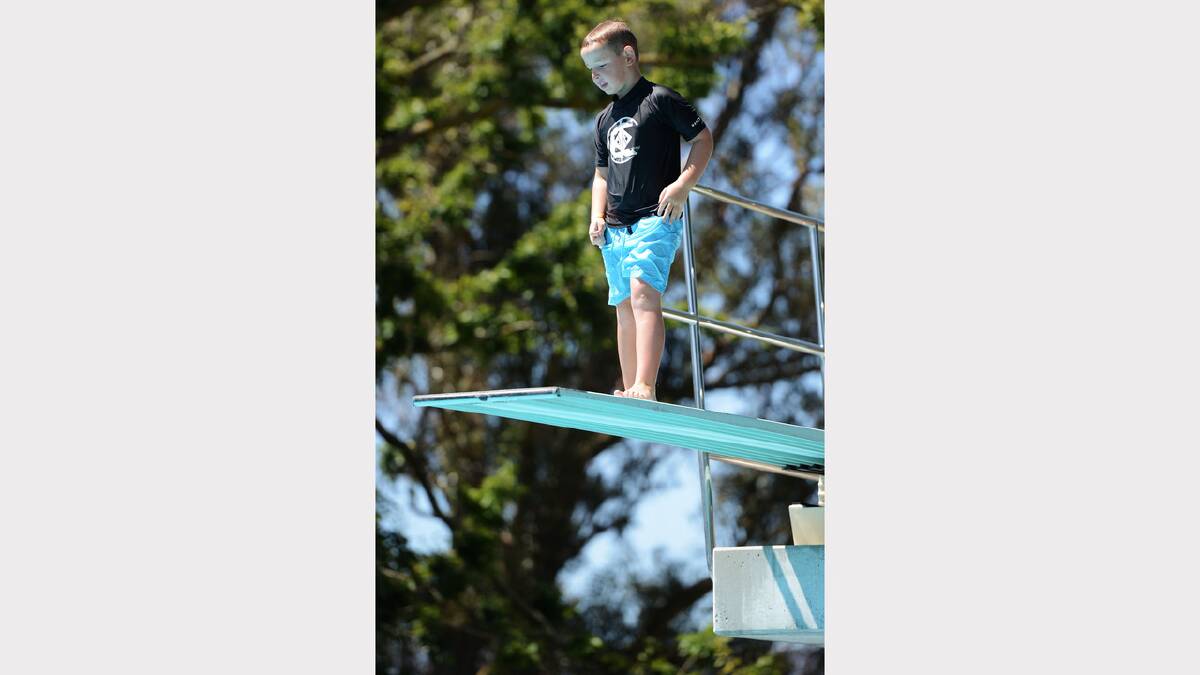 Seven-year-old Fletcher Cruden, of Devonport, pauses at the top of the diving board at the Launceston Aquatic Centre. Picture: Scott Gelston