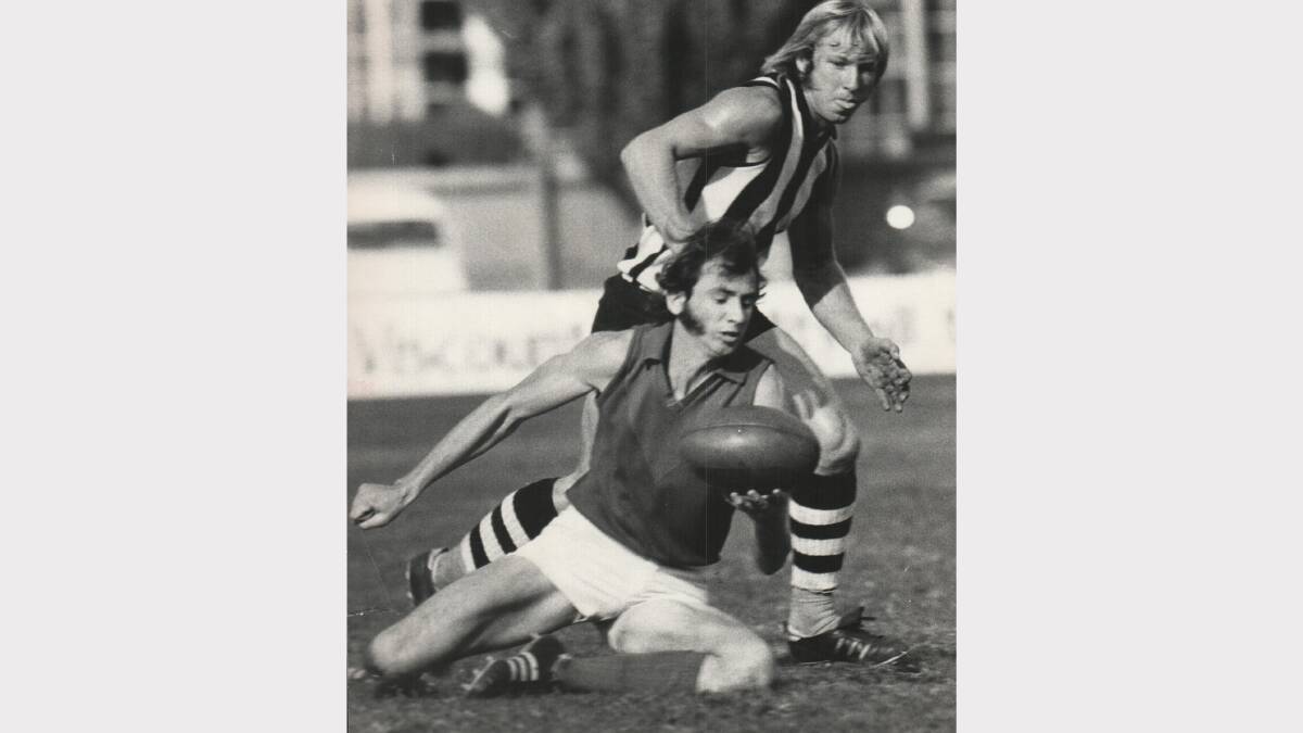 East Launceston's Terry Brown hits the ground but still manages to beat Scottsdale's Greg Martin with a handball. 1974.