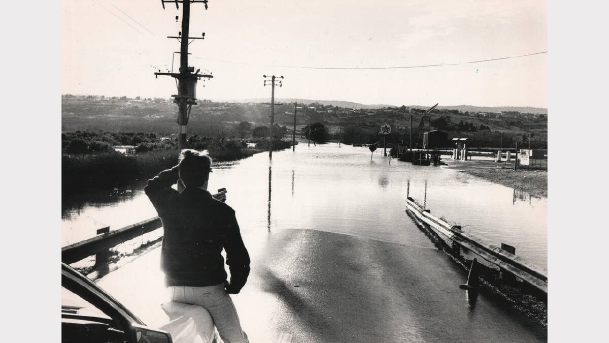 Water floods Henry Street near Racecourse Crescent. July 27, 1988.