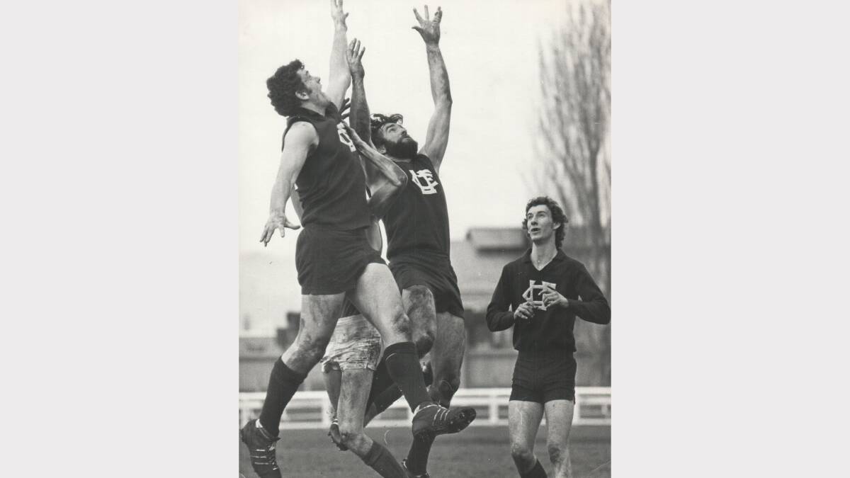 Launcesto's Len Duffy and Barry McAliece fly for the ball in a match against East Launceston. Paul Ellis looks on. 1974.