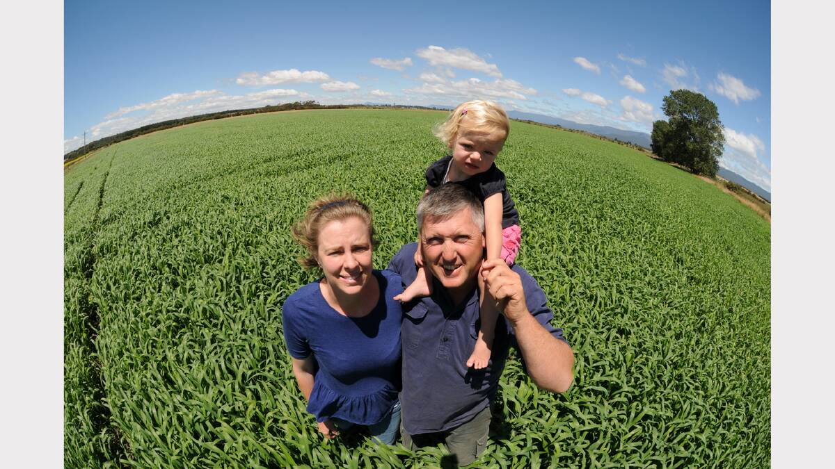 Anna and Rowan Clark with daughter Kate, 20 months, in the field of sorghum. Picture: Paul Scambler