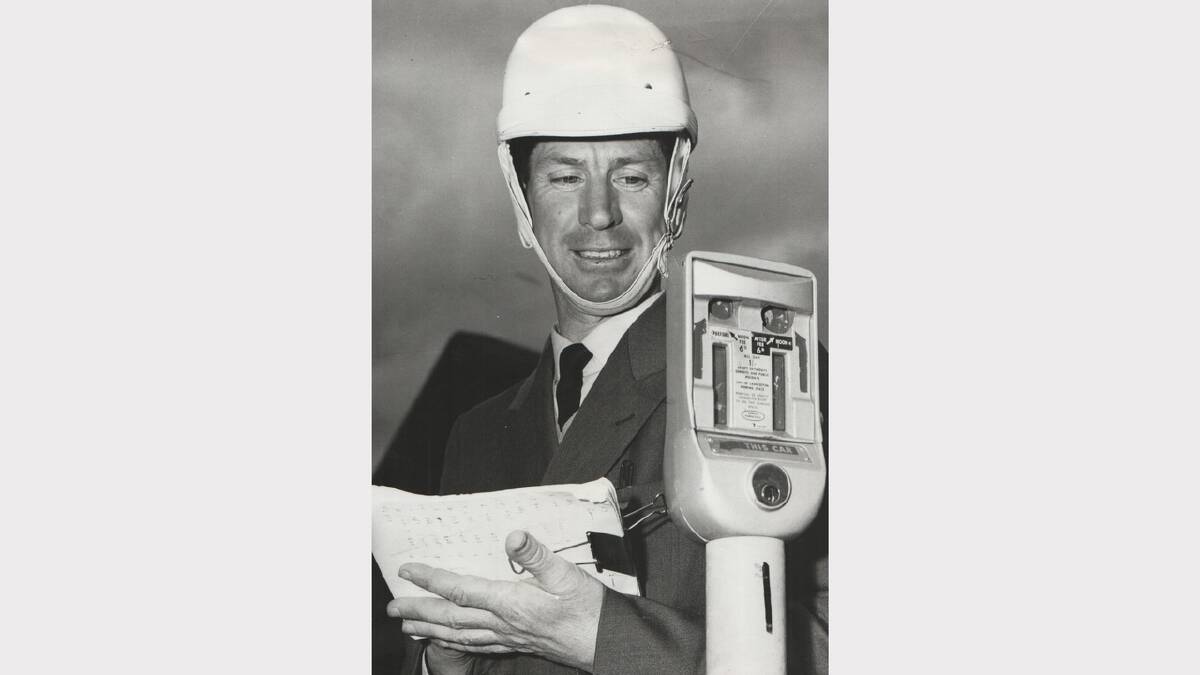 Mr Miller inspects a meter - note the fee on the side of the meter. October 12, 1967.