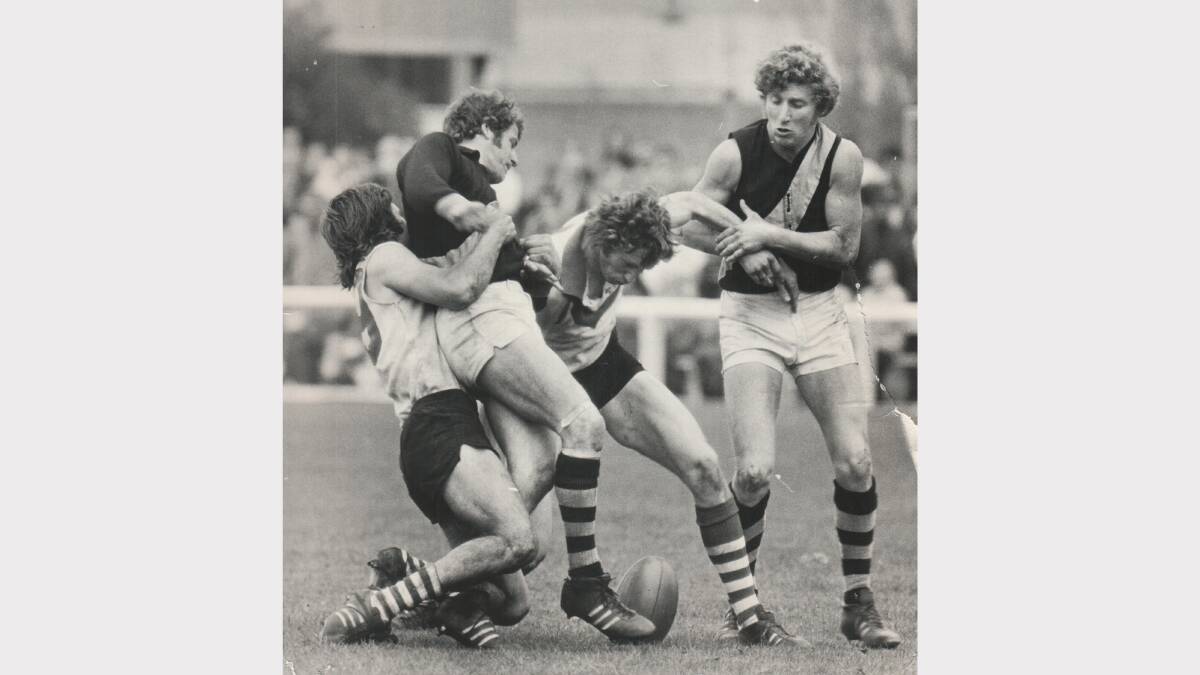 City-South's Geoff Lacey holds Burnie captain John Bonney, while City-South captain Stuart Barclay is held back by Burnie Brendon O'Boyle. 1974.