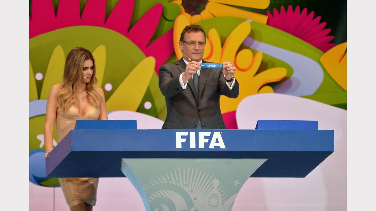    FIFA Secretary General Jerome Valcke holds up the name of Australia during the Final Draw for the 2014 FIFA World Cup Brazil at Costa do Sauipe Resort.