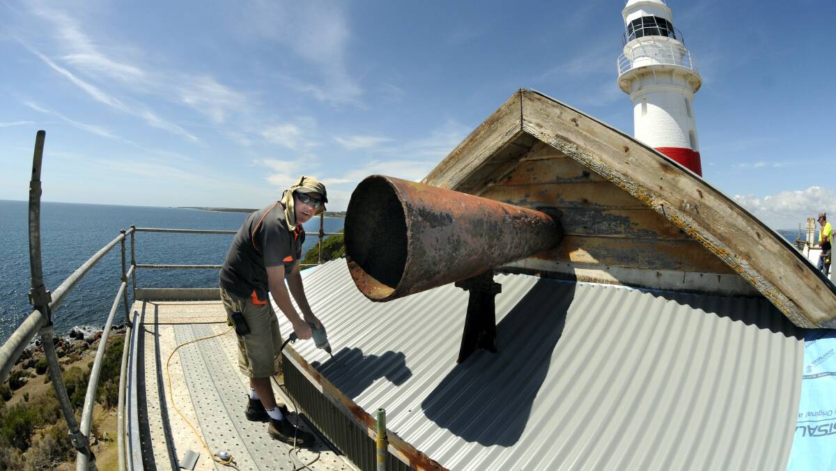 Mick Miller, of Ninedot Construction, works on the foghorn at the Low Head lighthouse.  Picture: PAUL SCAMBLER