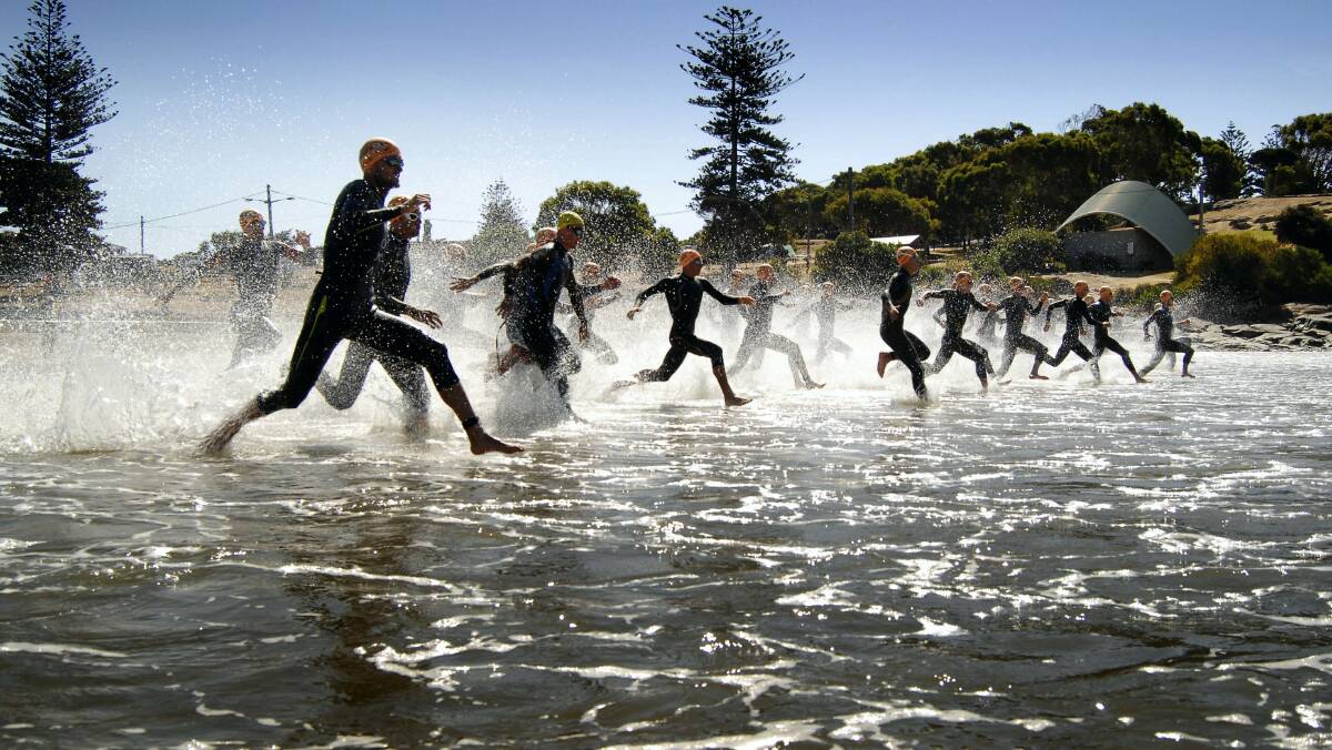 Competitors hit the water in yesterday's Devonport Triathlon.