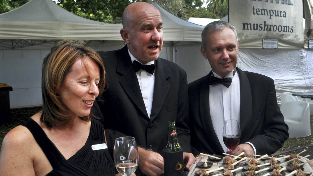 Festivale chairwoman Lou Clarke, Goaty Hill Wine's Tony Nieuwhof and Tamar Valley Wine Route chairman Anthony Woollams sample the food at last night's cocktail party. Picture: ZONA BLACK