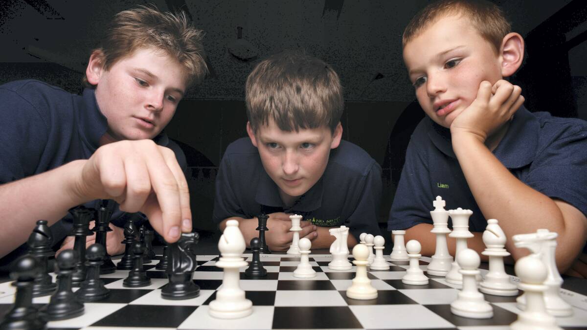 Josh Walker-Davis, 12, Lowell Mayne, 10, and Liam Rose-Nel, 8, prepare for the chess competition. Picture: SCOTT GELSTON