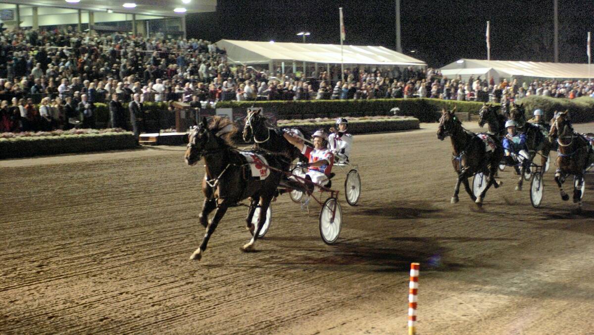 James Rattray drives Tasmanian pacer Beautide to the line to easily win Saturday night's Miracle Mile at Menangle. Picture courtesy of Michael Court.