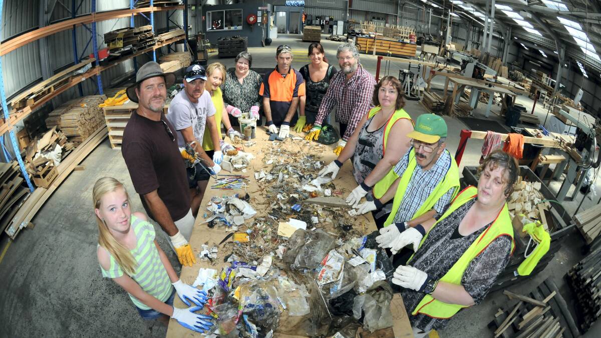 Eloise McKercher, 11, Peter Whish-Wilson, Darren McKercher, Jane Oakley-Lohm, Donna Bain, Ricky Kent, Tracie Bagger, Kim Booth, Anita Donald, Kevin Walker and Debbie Wardlaw  sorting rubbish at SelfHelp's Youngtown warehouse. Pictures: PAUL SCAMBLER