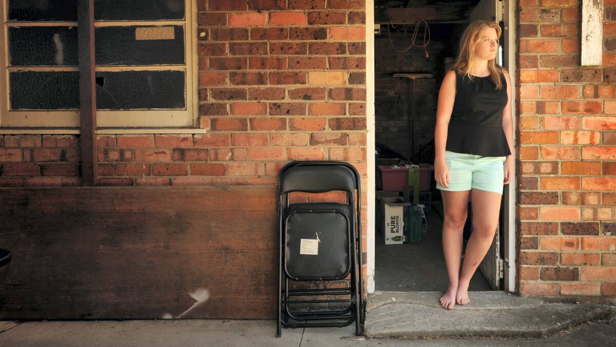 Brigitte Laherty, 17, of Kings Meadows, outside the shed from which several items were stolen.   Pictures: SCOTT GELSTON