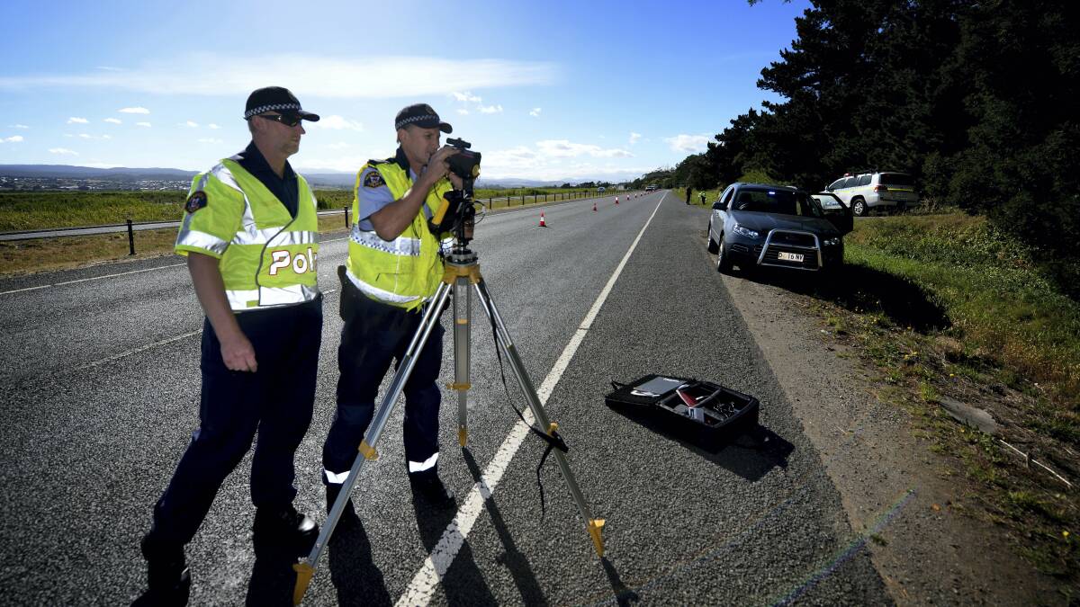 enior Constable Peter McCarron and First-Class Constable Nigel Housego at the scene of last week's fatal road accident involving a cyclist and a motor vehicle. Picture: GEOFF ROBSON