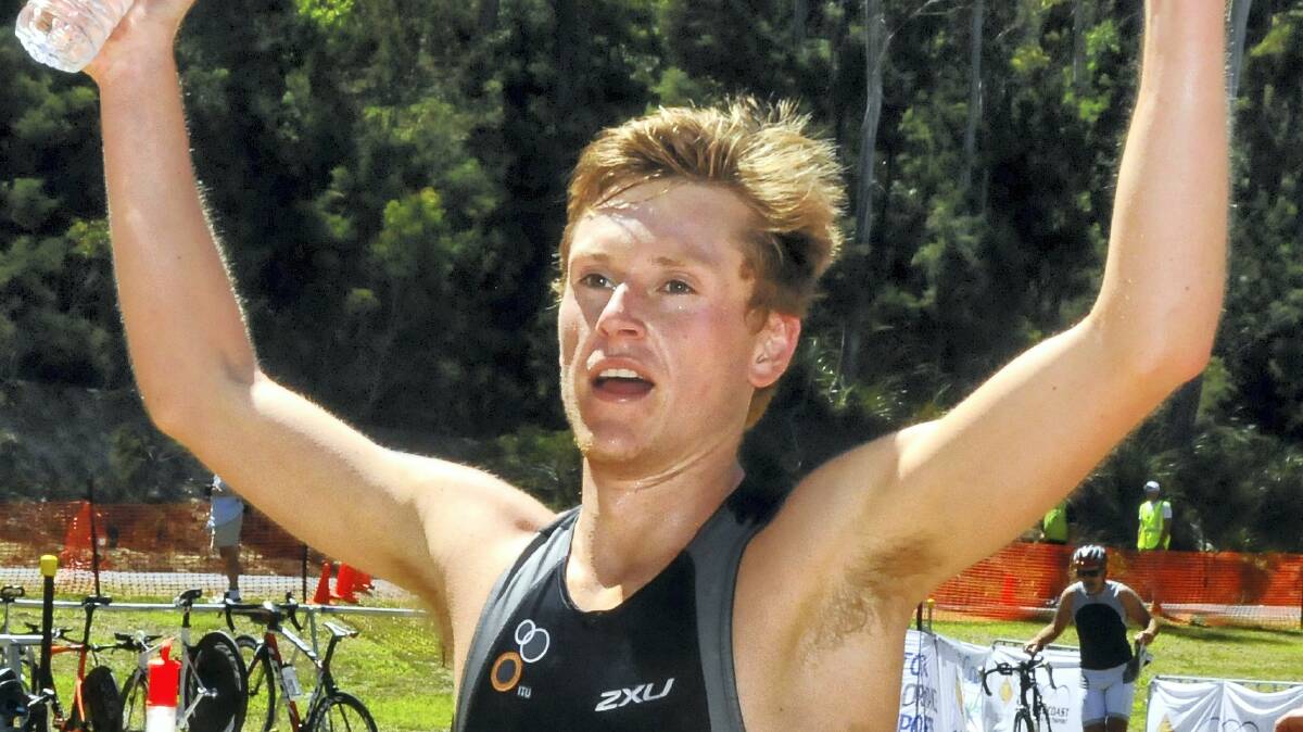Launceston's Dylan Evans shows his elation in winning race two of the Tasmanian Triathlon Series at Latrobe yesterday.  Picture: NEIL RICHARDSON