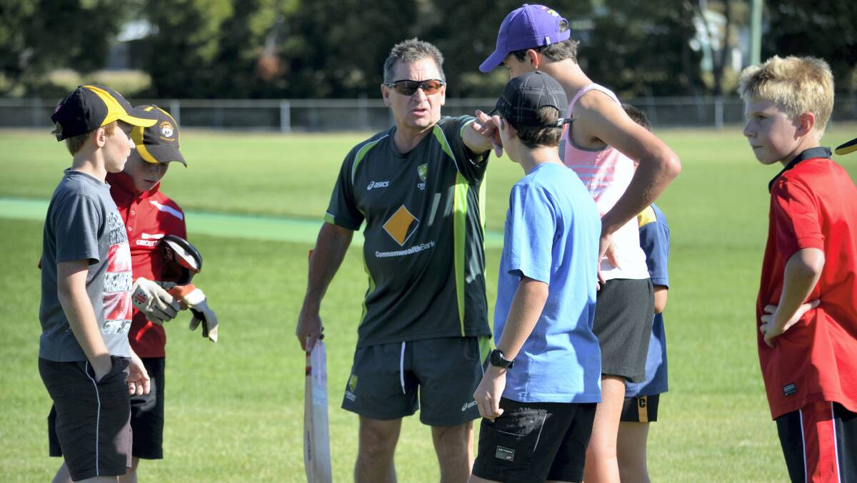 Former Tasmanian coach Tim Coyle talks to youngsters during a cricket clinic for beyondblue at Longford.