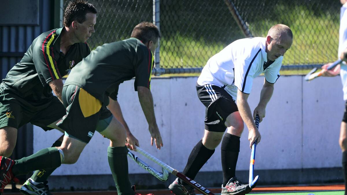 North's Craig Perkins pounces on the ball in Saturday's clash against the South in the intrastate masters hockey competition at St Leonards.