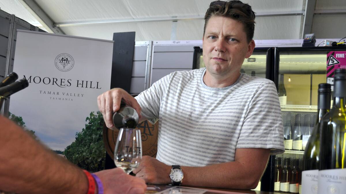 Moores Hill winemaker Julian Allport pours a glass of his award-winning 2013 Riesling at Taste of Tasmania. Picture: CALLA WAHLQUIST