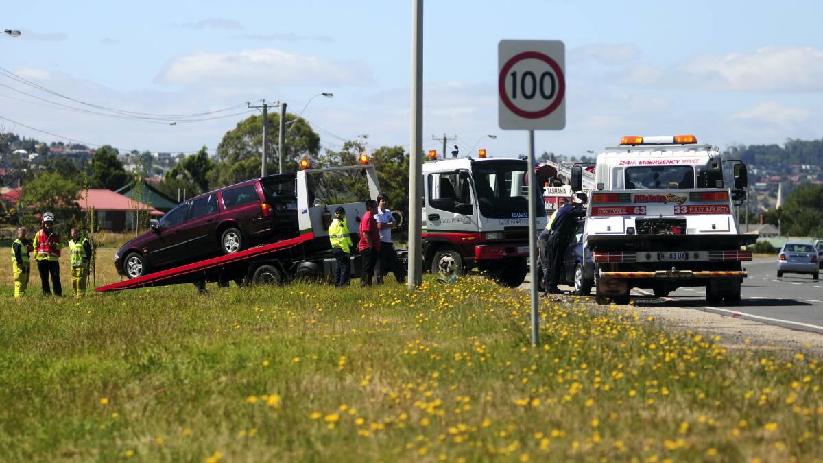 A damaged Ford Falcon station wagon is loaded onto a  tow truck after an accident on the East Tamar Highway yesterday. Picture: PETER SANDERS
