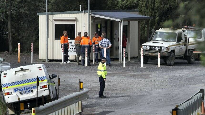 Emergency services personnel at Copper Mines of Tasmania operations at Queenstown,  where two men died yesterday.