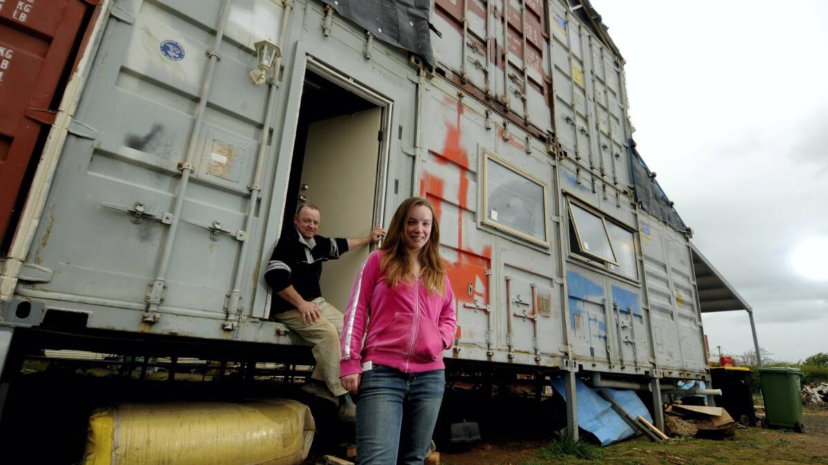 Graeme Turner and daughter Rhianna outside their shipping container home at Bishopsbourne.