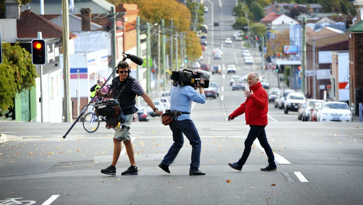 Time Walks presenter Tony Robinson crosses Launceston's Frederick Street with his production crew during filming in April last year.
