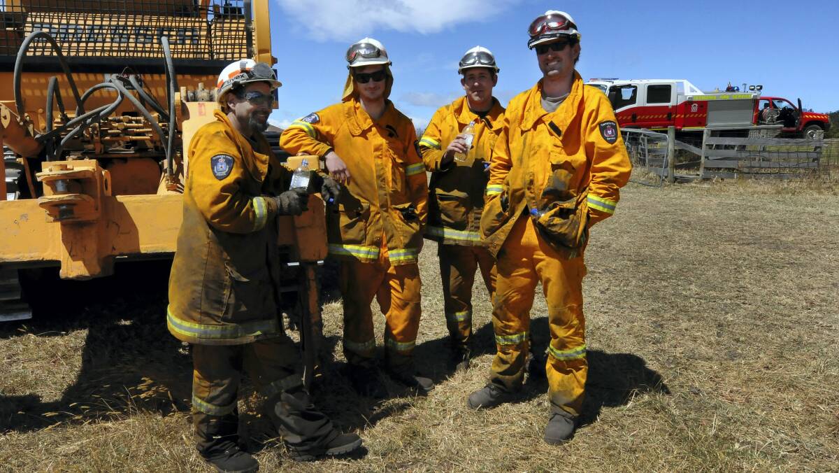 Mopping up  at the Holwell fire on the West Tamar yesterday are    Anthony Goodyer, Jarred Ranson and Greg Richards, of  Beaconsfield, and Ben Harper, of  Winkleigh.   Picture: NEIL RICHARDSON