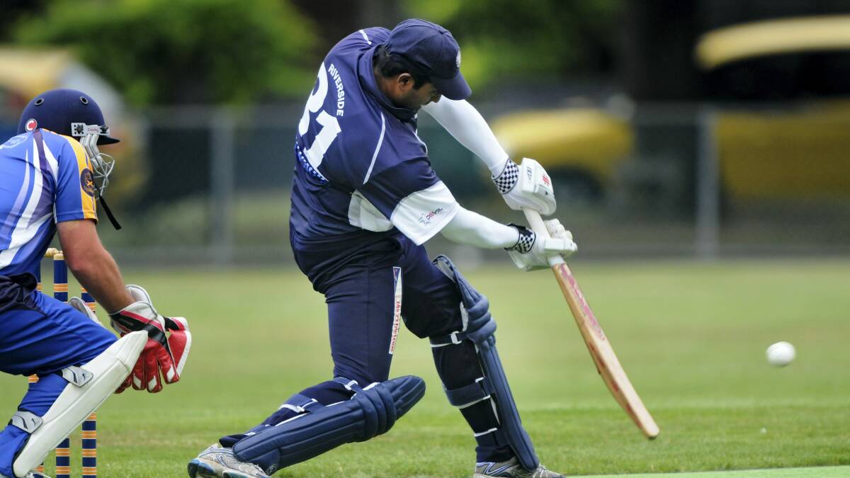  Riverside batsman Ramesh Sundra drives on the up as Trevallyn wicketkeeper Stuart Brown waits.  