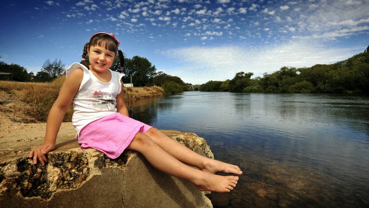  Ella Follows, 7, of Hadspen, sits by the South Esk River at Hadspen's Lions Park.   Picture: SCOTT GELSTON