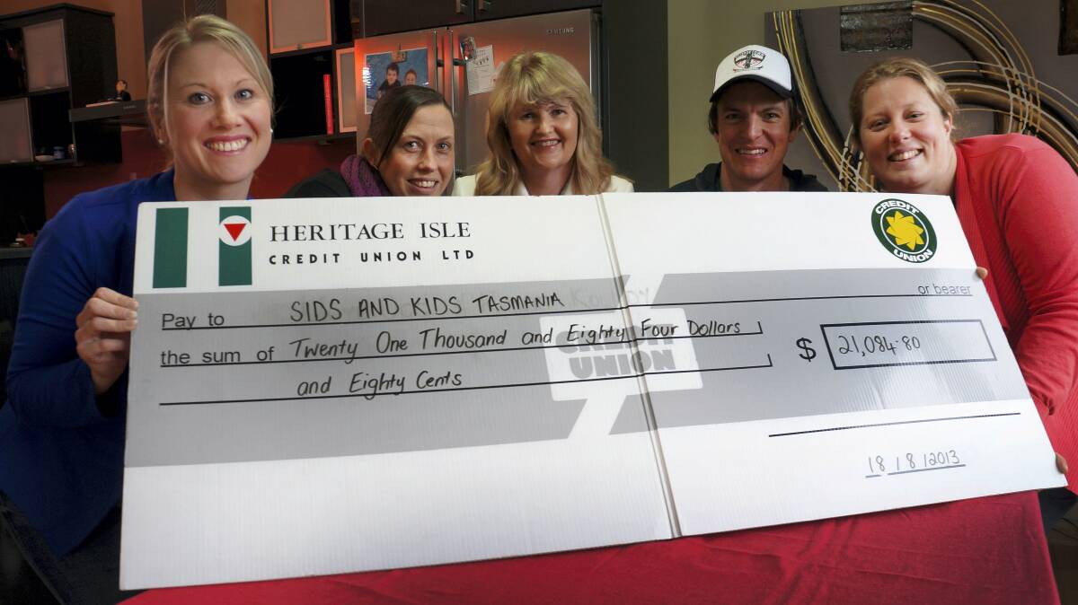 Friends Kim Kettle, Anna Delphine, Anthony Axton and Kate Barnard present a cheque for $21,000 to SIDS Tasmania executive officer Sharon Davis (centre). The money was raised through the Red Tie Ball.