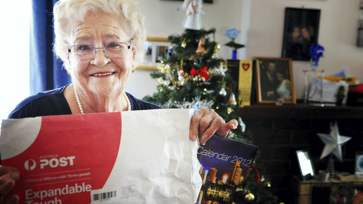 Kath Maloney with her calendar that was sent from Surfers Paradise on December 14, 2011. It arrived on Wednesday.