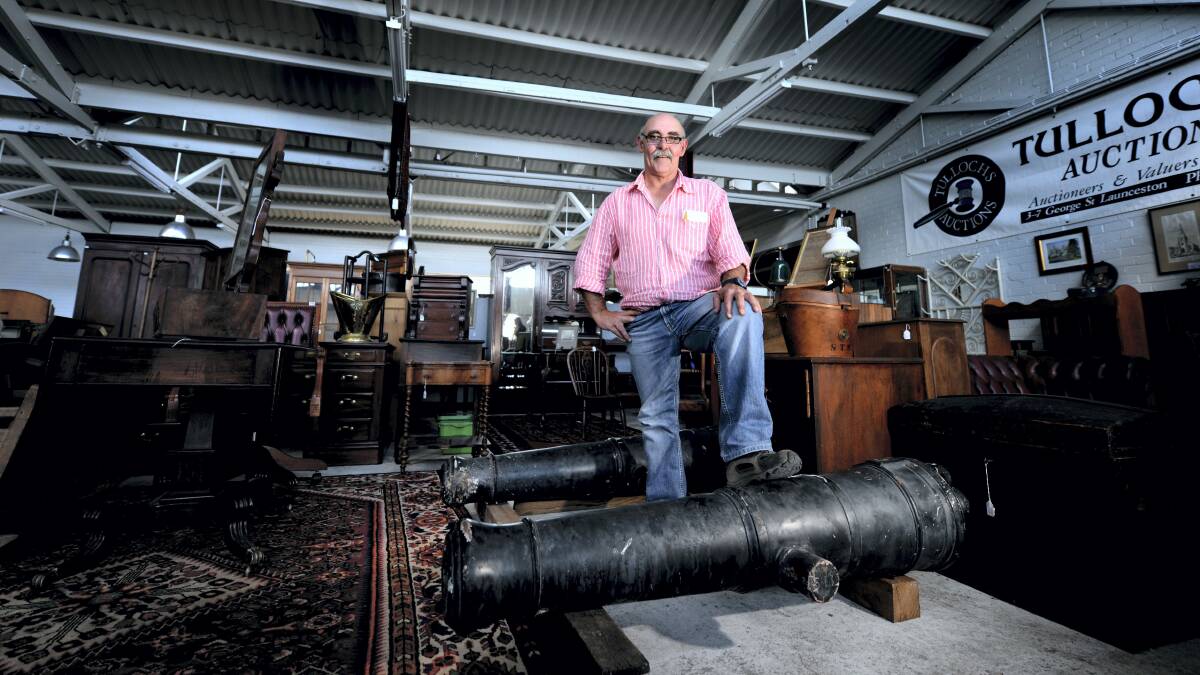 Tullochs Auctions director Scott Millen with two 18th-century cannons which will be auctioned today.  Picture: GEOFF ROBSON