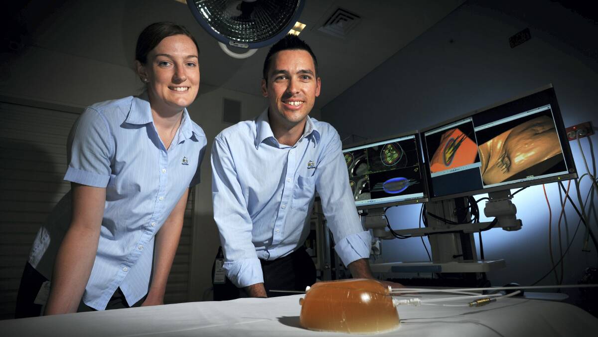 Holman Clinic radiation therapists Liz Howell  and Ian Hodgetts with a breast tissue model and displays of the brachytherapy procedure. Picture: SCOTT GELSTON