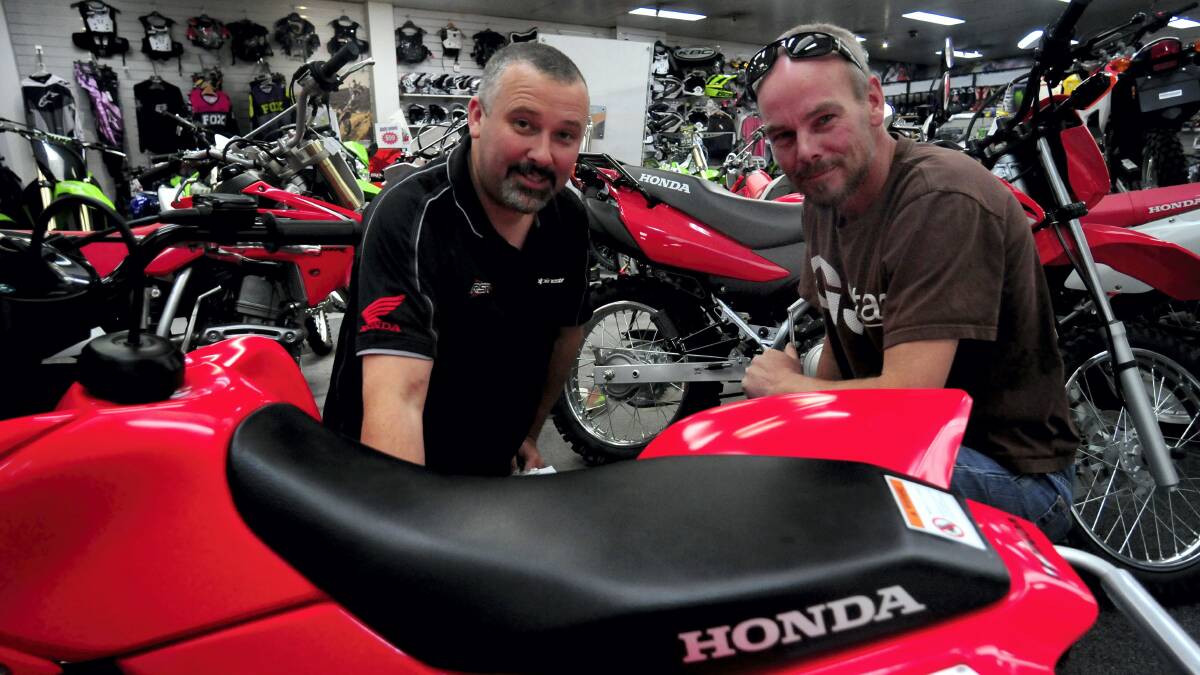 Motorcycle City sales manager Jason Spencer chats to customer Adrian Gardam about child-appropriate quad bikes.