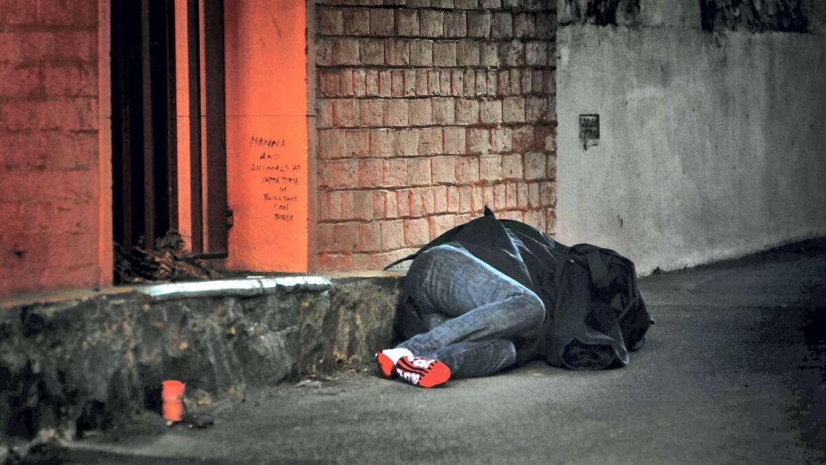 A homeless person sleeps in an alley in central Launceston.